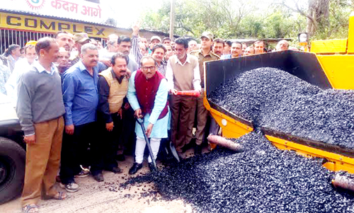 Former DyCM and BJP MLA, Dr Nirmal Singh kick-starting blacktopping work of road at Billawar on Wednesday. Former DyCM and BJP MLA, Dr Nirmal Singh kick-starting blacktopping work of road at Billawar on Wednesday.