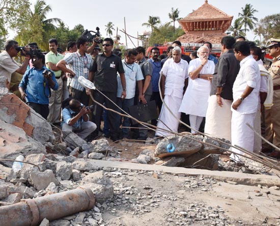 Prime Minister Narendra Modi and Chief Minister of Kerala Oommen Chandy take stock of the situation at Puttingal temple, Paravur, in Kollam, Kerala on Sunday. (UNI) Prime Minister Narendra Modi and Chief Minister of Kerala Oommen Chandy take stock of the situation at Puttingal temple, Paravur, in Kollam, Kerala on Sunday. (UNI)