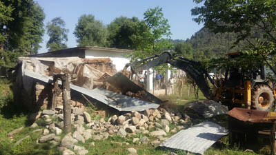 A JCB demolishing illegal structures raised on Govt land at Gohlad in Mendhar on Monday. A JCB demolishing illegal structures raised on Govt land at Gohlad in Mendhar on Monday.