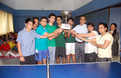 Winners of Inter-House TT finals holding trophy while posing for group photograph at KC Sports Club in Jammu on Wednesday. Winners of Inter-House TT finals holding trophy while posing for group photograph at KC Sports Club in Jammu on Wednesday.