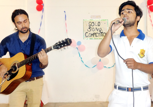 Student singing a song during solo singing competition. Student singing a song during solo singing competition.