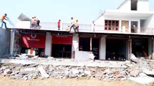 An illegal structure being demolished at Jagti on Monday. An illegal structure being demolished at Jagti on Monday.