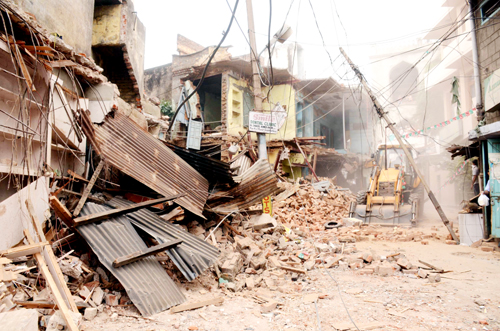 Commercial cum residential structures being demolished by administration at Jammu on Tuesday. Commercial cum residential structures being demolished by administration at Jammu on Tuesday.