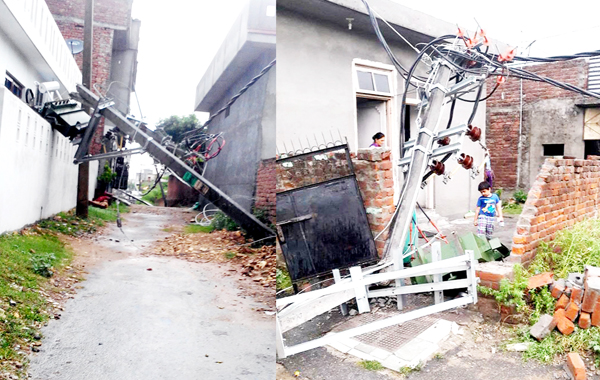Two uprooted electric poles damaged public property at Vikas Colony in Lower Roop Nagar area of Jammu on Friday. —Excelsior/Rakesh Two uprooted electric poles damaged public property at Vikas Colony in Lower Roop Nagar area of Jammu on Friday. —Excelsior/Rakesh