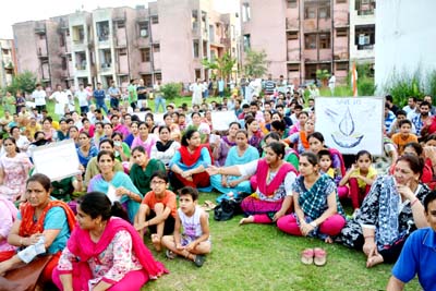 Migrant employees holding protest in Jagti township on Monday. Migrant employees holding protest in Jagti township on Monday.