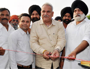 PHE Minister, Sham Lal Choudhary inaugurating blacktopping of road on Tuesday. PHE Minister, Sham Lal Choudhary inaugurating blacktopping of road on Tuesday.