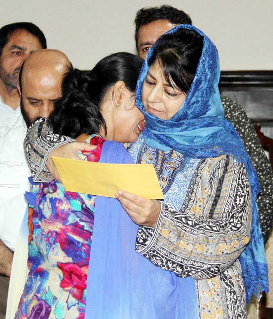 Chief Minister Mehbooba Mufti consoles a girl as she hands over appointment letter to her in Jammu on Monday. Chief Minister Mehbooba Mufti consoles a girl as she hands over appointment letter to her in Jammu on Monday.