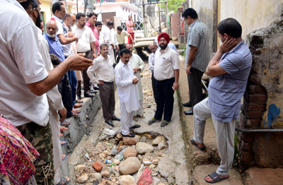 JMC Commissioner inspecting a Nallah in Jammu city on Sunday. JMC Commissioner inspecting a Nallah in Jammu city on Sunday.