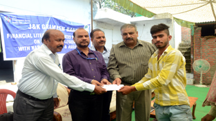 DDM, NABARD, Madan Lal and others presenting a cheque to a beneficiary of KCC. DDM, NABARD, Madan Lal and others presenting a cheque to a beneficiary of KCC.