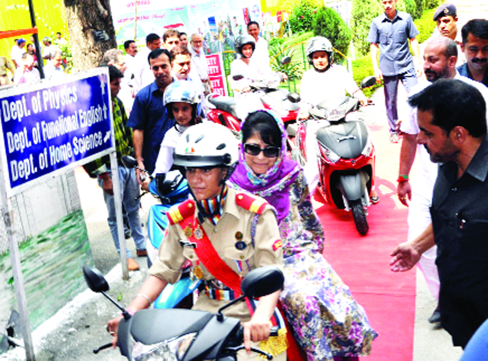 Chief Minister Mehbooba Mufti enjoying Scooty ride with college girl in Jammu on Friday. -Excelsior/Rakesh Chief Minister Mehbooba Mufti enjoying Scooty ride with college girl in Jammu on Friday. -Excelsior/Rakesh