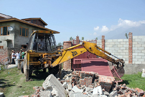 Enforcement wing of LAWDA demolishing illegal structures on Wednesday. Enforcement wing of LAWDA demolishing illegal structures on Wednesday.