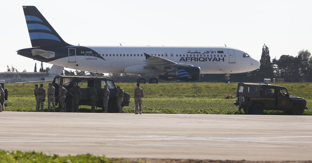 Hijackers threaten to blow up Libyan plane diverted to Malta Hijackers threaten to blow up Libyan plane diverted to Malta