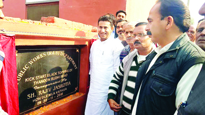 MLA Kathua Rajiv Jasrotia kick starting black topping of Budhi road on Wednesday. MLA Kathua Rajiv Jasrotia kick starting black topping of Budhi road on Wednesday.