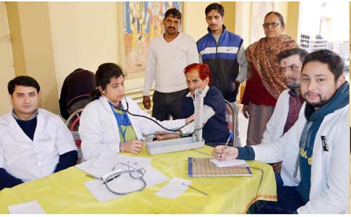 Doctor examining a patient during free medical camp. Doctor examining a patient during free medical camp.