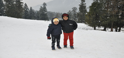 Tourists enjoying snow at Pahalgam on Sunday. — Excelsior/Sajad Dar Tourists enjoying snow at Pahalgam on Sunday. — Excelsior/Sajad Dar
