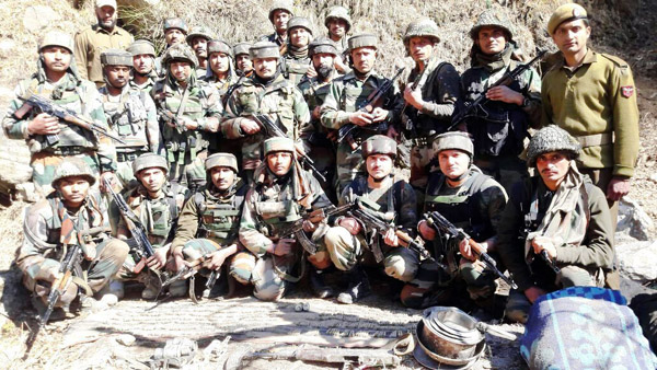 Security personnel pose with arms and ammunition recovered at Bonjwah, Kishtwar on Friday. Security personnel pose with arms and ammunition recovered at Bonjwah, Kishtwar on Friday.