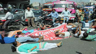 Agitating contractual lecturers laying down on road during protest demonstration on Friday. -Excelsior/Rakesh Agitating contractual lecturers laying down on road during protest demonstration on Friday. -Excelsior/Rakesh