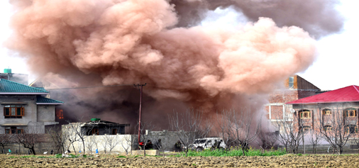 Smoke billowing out from house where militants were holed up at Chadoora area of Budgam district. -Excelsior/Shakeel Smoke billowing out from house where militants were holed up at Chadoora area of Budgam district. -Excelsior/Shakeel