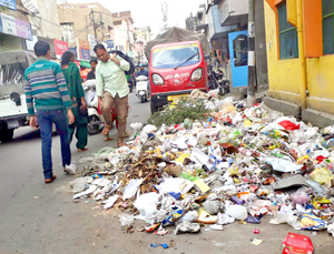 Heap of garbage lying on Exchange Road due to strike of Safai Karamcharis of JMC. -Excelsior/Rakesh Heap of garbage lying on Exchange Road due to strike of Safai Karamcharis of JMC. -Excelsior/Rakesh