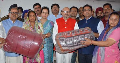 Deputy Chief Minister Dr Nirmal Singh and MLA Dr Gagan Bhagat distributing blankets at a relief camp on Tuesday. Deputy Chief Minister Dr Nirmal Singh and MLA Dr Gagan Bhagat distributing blankets at a relief camp on Tuesday.