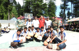 Winners of basketball tournament posing alongwith Army officers at Handwara in Valley on Wednesday. Winners of basketball tournament posing alongwith Army officers at Handwara in Valley on Wednesday.
