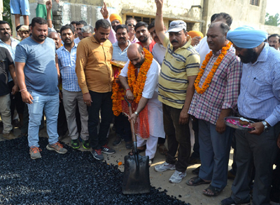 Minister for Health & Medical Education, Bali Bhagat starting blacktopping work on Sunday. Minister for Health & Medical Education, Bali Bhagat starting blacktopping work on Sunday.