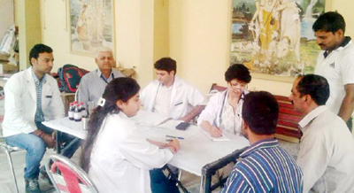 Doctors prescribing medicines to patients during a medical camp at Panchbhatkar temple in Jammu.