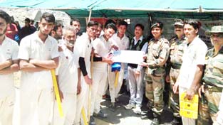 Army officer awarding winning team of a cricket tournament held at Harniyal village of Tehsil Khari in district Ramban. -Excelsior/Parvaiz Army officer awarding winning team of a cricket tournament held at Harniyal village of Tehsil Khari in district Ramban. -Excelsior/Parvaiz