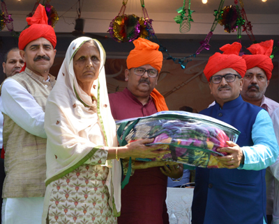 Deputy CM and others honouring family member of martyr. Deputy CM and others honouring family member of martyr.