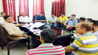 MLA Sat Sharma chairing a meeting of officers on Thursday.