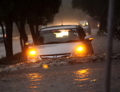 A car moving through waterlogged road during rain at Gandhi Nagar in Jammu on Thursday. —Excelsior/Rakesh A car moving through waterlogged road during rain at Gandhi Nagar in Jammu on Thursday. —Excelsior/Rakesh