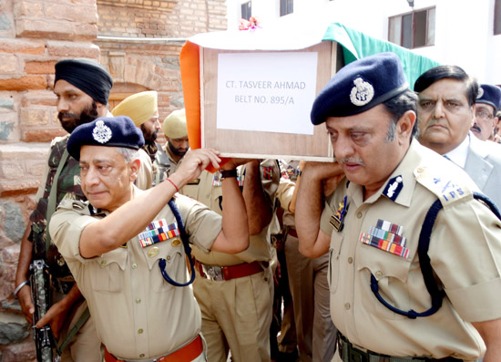 DGP Dr SP Vaid and IG Kashmir Munir Khan lend shoulder to the coffin of constable Tasveer Ahmad in Srinagar on Saturday. -Excelsior/ Shakeel DGP Dr SP Vaid and IG Kashmir Munir Khan lend shoulder to the coffin of constable Tasveer Ahmad in Srinagar on Saturday. -Excelsior/ Shakeel