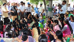 Minister for Industries and Commerce Chander Prakash Ganga launching blacktopping work of road. Minister for Industries and Commerce Chander Prakash Ganga launching blacktopping work of road.