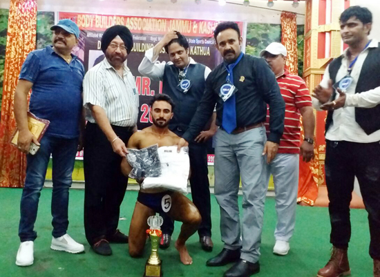 Winner of Bodybuilding Championship posing along with dignitaries in Kathua. Winner of Bodybuilding Championship posing along with dignitaries in Kathua.