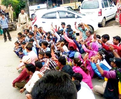 Villagers and students staging dharna on Dhar road. Villagers and students staging dharna on Dhar road.