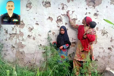 A woman shows her badly damaged house at Gohlad in Mendhar sector on Saturday. (Inset) Martyr Jagram Singh Tomar. A woman shows her badly damaged house at Gohlad in Mendhar sector on Saturday. (Inset) Martyr Jagram Singh Tomar.