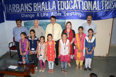 Managing Trustee of HBET, Harbans Bhalla and other guests posing with children during a scholarship camp. Managing Trustee of HBET, Harbans Bhalla and other guests posing with children during a scholarship camp.