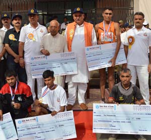 Winners of Half Marathon posing along with Minister for PHE, Sham Choudhary in Jammu on Sunday. Winners of Half Marathon posing along with Minister for PHE, Sham Choudhary in Jammu on Sunday.