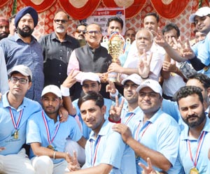 Deputy Chief Minister Dr Nirmal Singh and others presenting PDD Premier League title trophy to winner team at Jammu on Sunday. Deputy Chief Minister Dr Nirmal Singh and others presenting PDD Premier League title trophy to winner team at Jammu on Sunday.