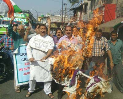 JWAM activists torching effigy of Central Government during a protest at New Plot in Jammu. JWAM activists torching effigy of Central Government during a protest at New Plot in Jammu.