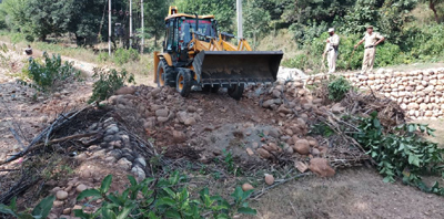 Revenue authorities clearing encroachments on State land near Maira Mandrian on Monday. Revenue authorities clearing encroachments on State land near Maira Mandrian on Monday.