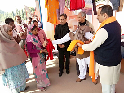 RSS leader Parshotam Dadeechi distributing clothes among needy alongwith Shakti Dutt Sharma at Thathar on Saturday. RSS leader Parshotam Dadeechi distributing clothes among needy alongwith Shakti Dutt Sharma at Thathar on Saturday.