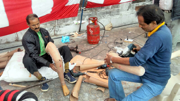 A technician fabricating an artificial limb (right) and a physically challanged man wearing an artificial limb (left) during a camp at Jammu. A technician fabricating an artificial limb (right) and a physically challanged man wearing an artificial limb (left) during a camp at Jammu.