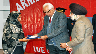 Governor NN Vohra honouring war widows at Army Flag Day function at Jammu on Wednesday. Governor NN Vohra honouring war widows at Army Flag Day function at Jammu on Wednesday.