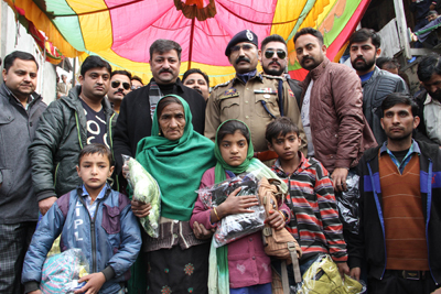 Team Jammu members and SSP Ramban with the people who were given woolens on Sunday. Team Jammu members and SSP Ramban with the people who were given woolens on Sunday.