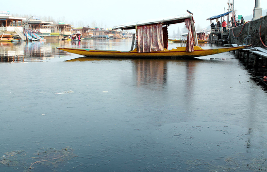The water of world famous Dal lake was frozen on Sunday. (UNI)