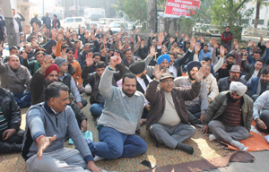 Government pharmacists sitting on dharna in the premises of DHS Jammu on Monday. — Excelsior/Rakesh Government pharmacists sitting on dharna in the premises of DHS Jammu on Monday. — Excelsior/Rakesh