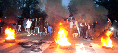 Protesters blocking road near main gate of Jammu University on Friday — Excelsior/Rakesh Protesters blocking road near main gate of Jammu University on Friday — Excelsior/Rakesh