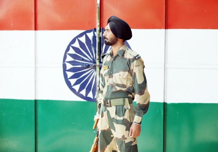 Indian Border Security Force solider stands guard at Suchategarh India-Pakistan international border. Excelsior/Rakesh