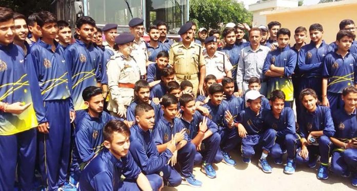 Police officers with boys and girls who were sent on Bharat Darshan.